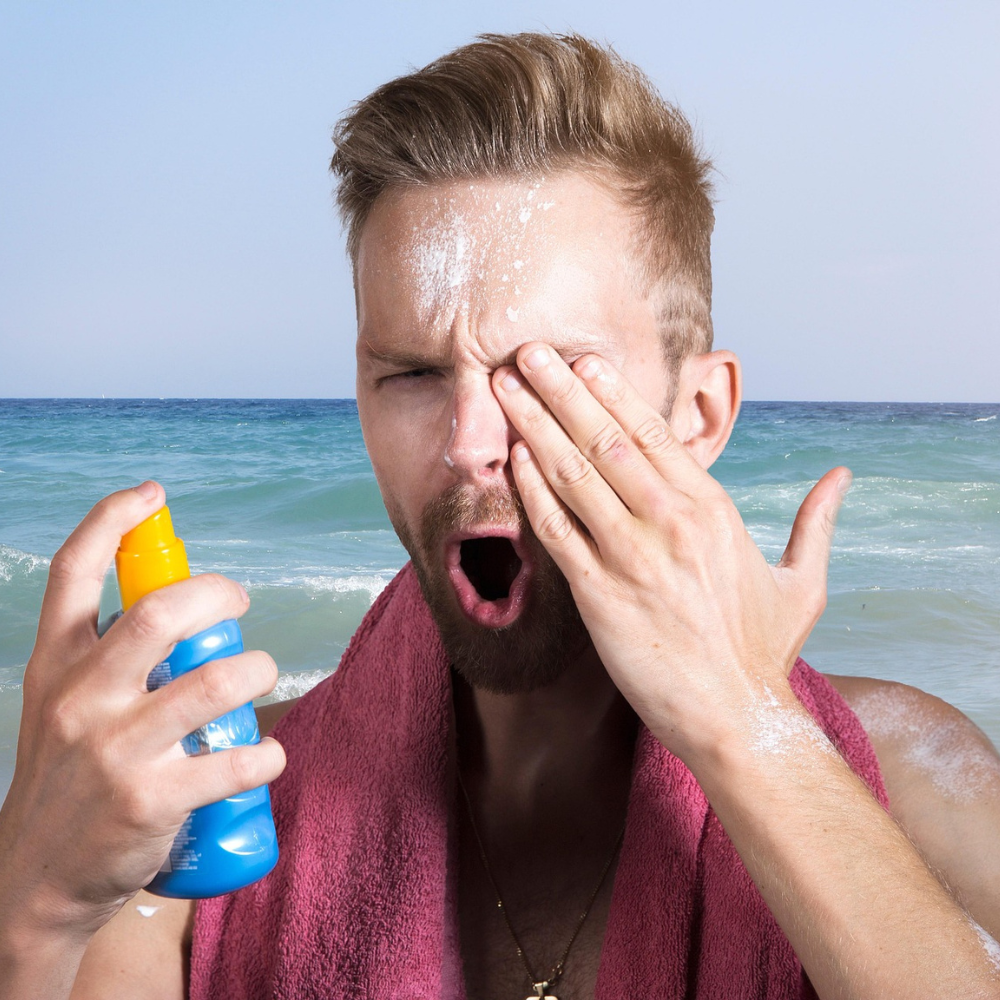 A beach goer that got sun screen in his eye.